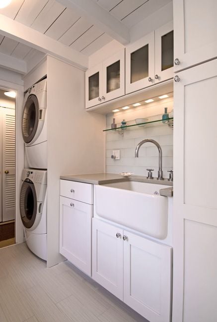 Stacked laundry with sink for hand washing and lots of storage featured on Remodelaholic.com