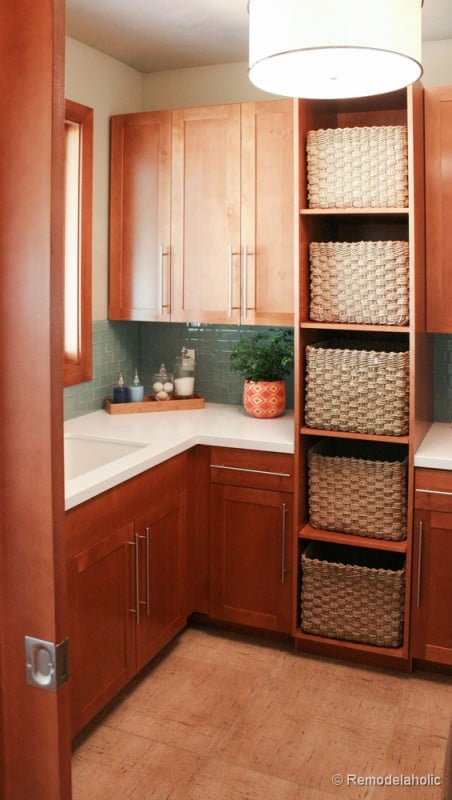 Shelves with basket storage in the laundry room. Fabulous Laundry room design ideas from @Remodelaholic